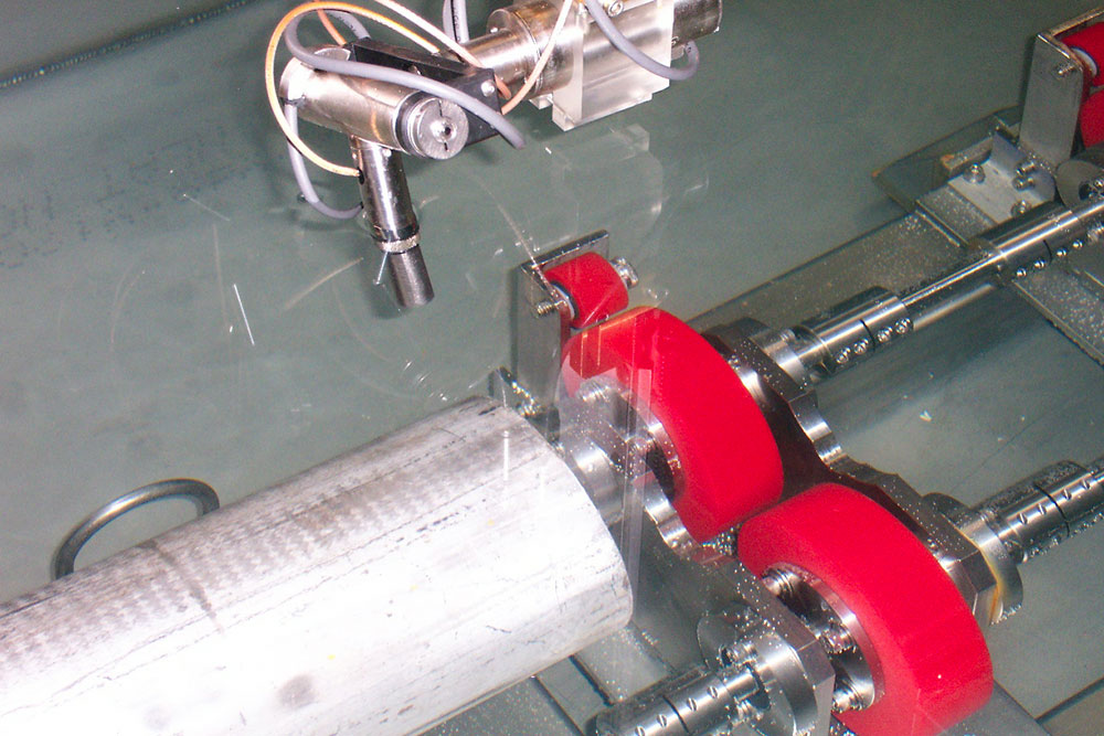 Close-up of SDI precision ultrasonic scan head testing a part